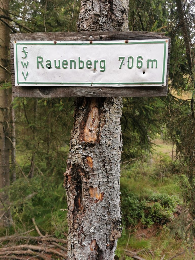 Infoschild an einem Baumstamm